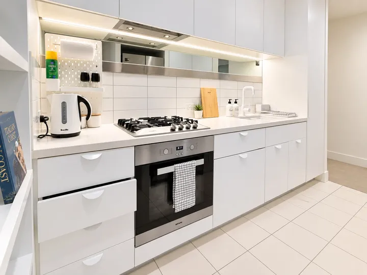 White kitchen with oven and gas cooktop