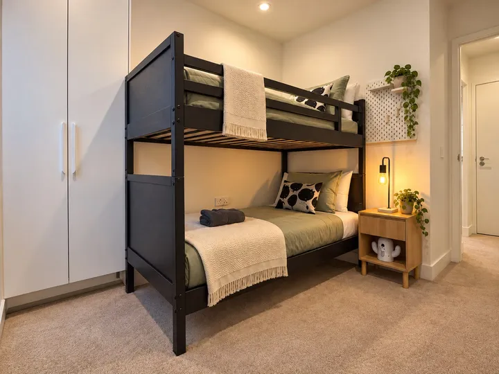 Bunk bedroom with bedside lighting