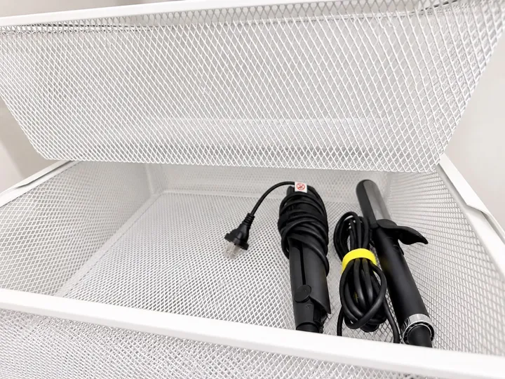 Hair styling tools in storage basket