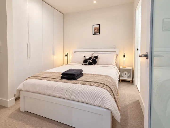 Bedroom with fresh linen and bedside lamps